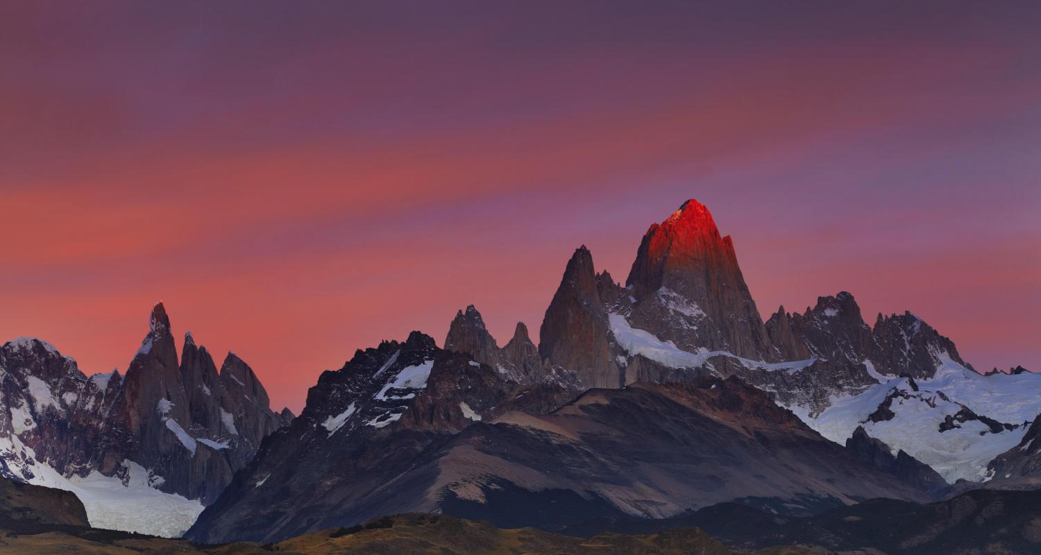 Image of vast open grasslands and jagged mountains in Patagonia
